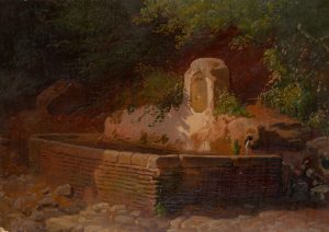 Brunnen am Felsen mit Sträuchern bewachsen